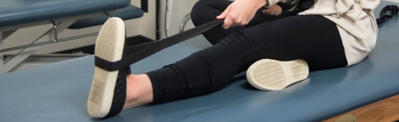 Student stretching leg at University Health Services' Physical Therapy department