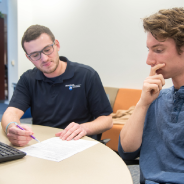 A Peer Career Assistant helps a student with a resume review.