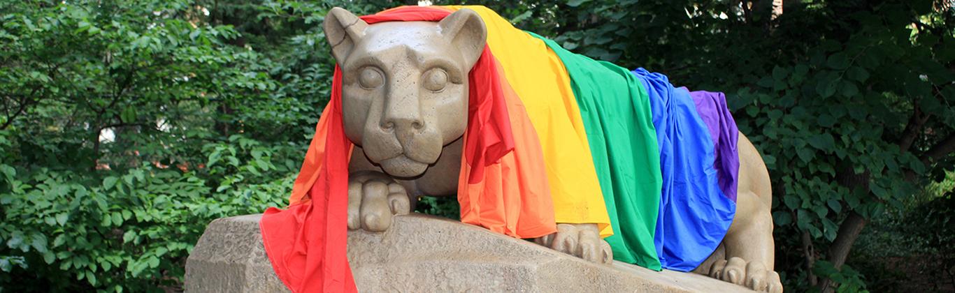 Penn State Nittany Lion Shrine statue draped in a rainbow flag