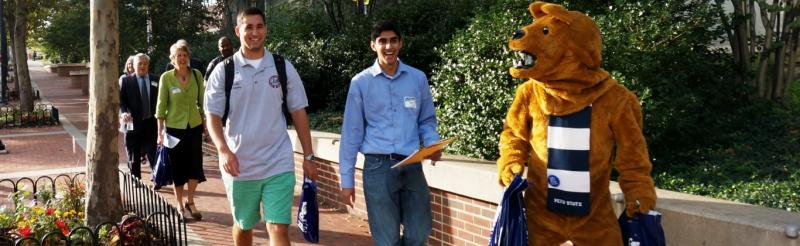 Nittany lion walks with student, University, and government leaders.
