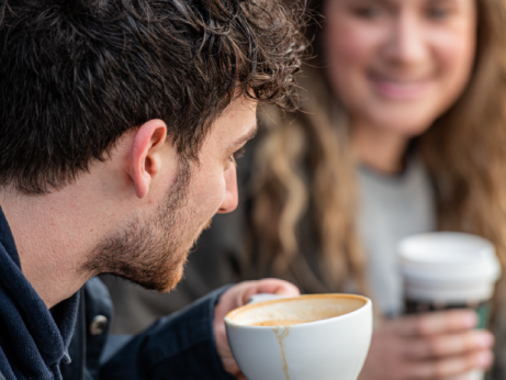 Two students drinking coffee and chatting
