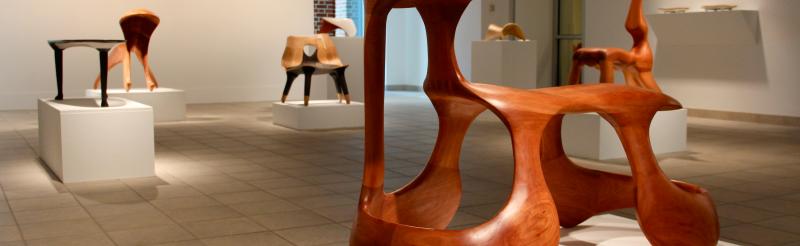 Abstract anthropomorphic wooden chairs carved by Keunho Peter Park