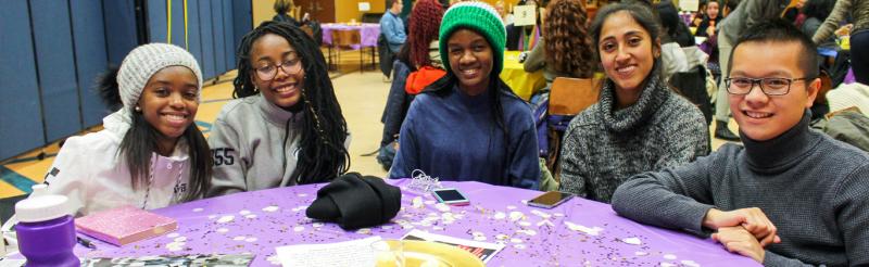 Students sitting at a table in Heritage Hall during a MLK event