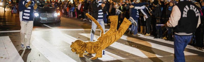 Nittany Lion dancing at Allen Street during the Homecoming Parade