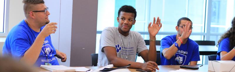 Students in a conference room during a meeting