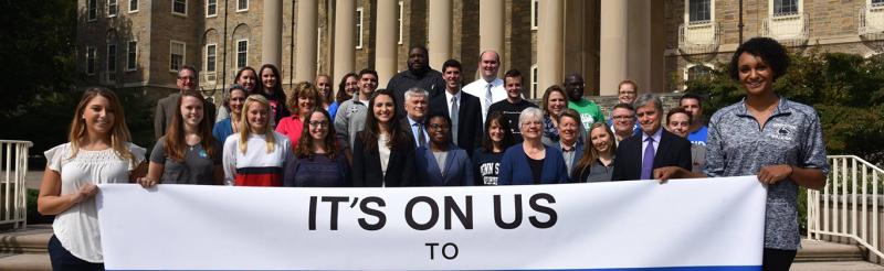 Group holding banner that says "It's On Us"