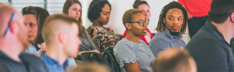 A staff member speaks during a Residence Life team meeting.