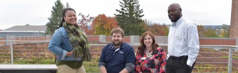 A group of Residence Life staff pose on the HUB Green Roof.