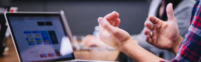 Hands in front of a computer