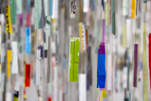 Strings of plastic hang from the ceiling