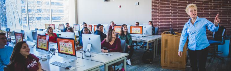 faculty member teaching in front of class