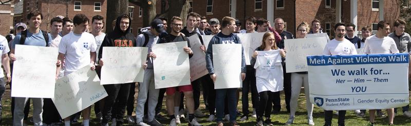 Students in group holding signs