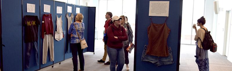 People looking at an exhibit of clothing