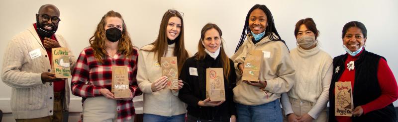 Group of people holding up handmade lunchbags