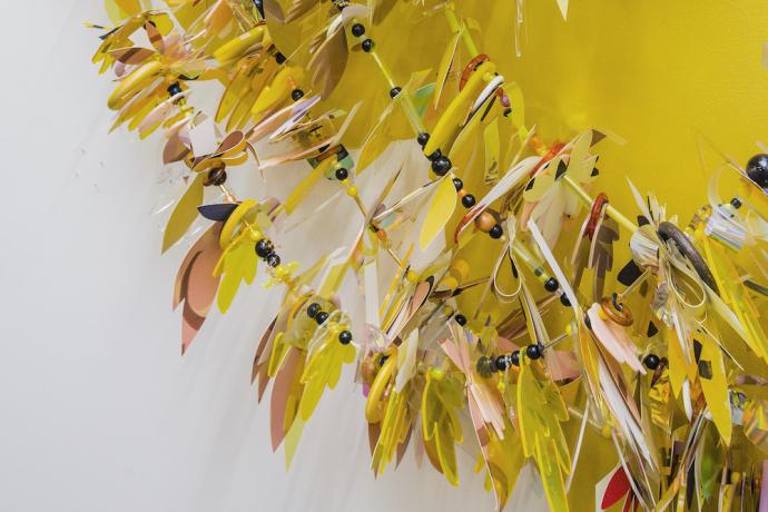Yellow Garland (detail), 2020, laser cut acrylic, found objects, hand cut and painted paper, beads, steel cable, dimensions vary. Photo by Jill Fannon