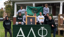 Alpha Delta Phi brothers posing outside of their house